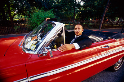 man in red car