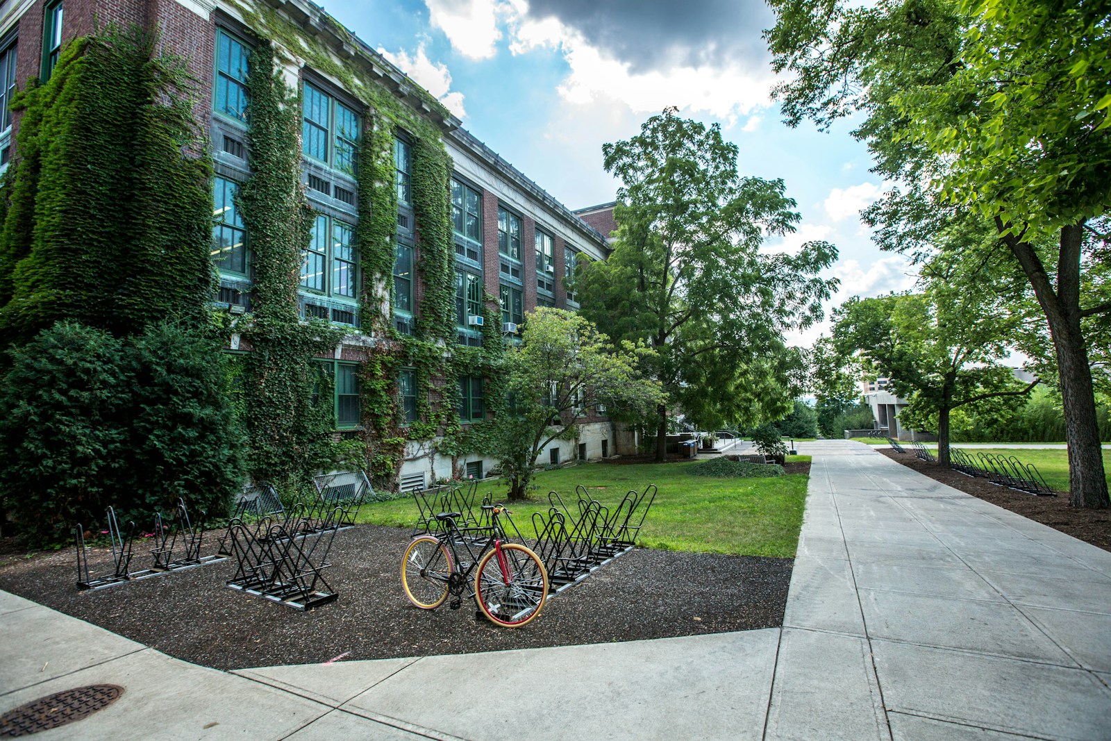 black bicycle parked in front of building on college campus