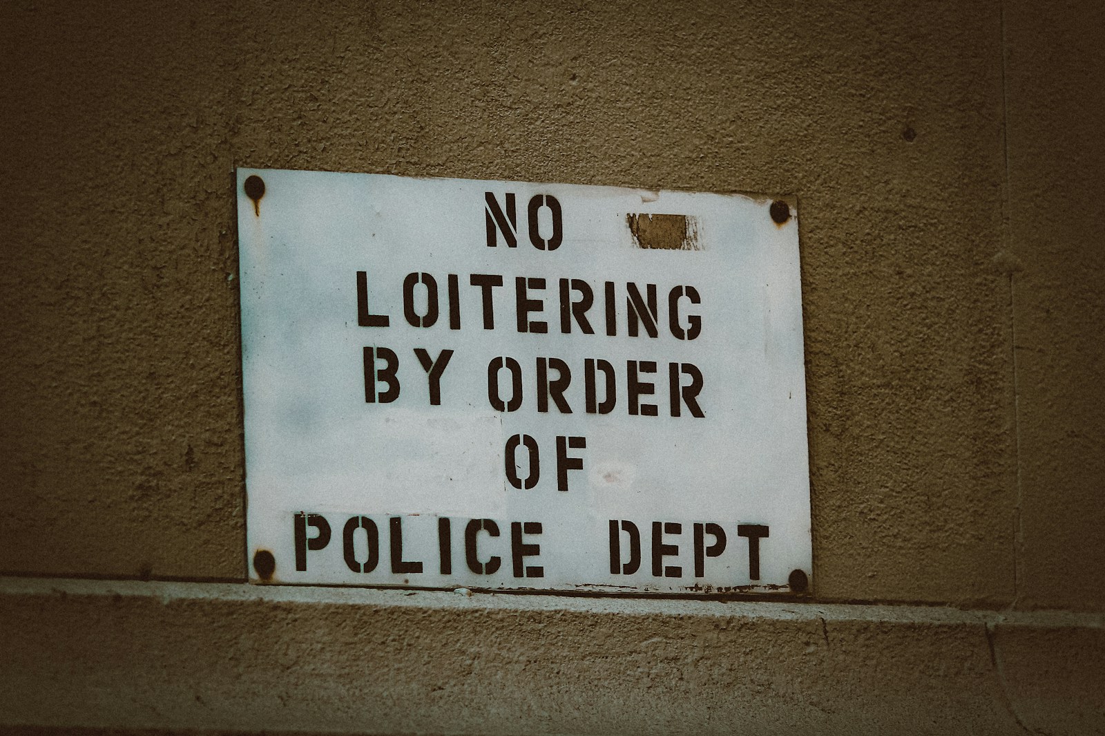 white and black quote board reading No Loitering